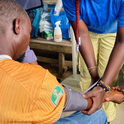 Healthcare worker measures a participant’s blood pressure
