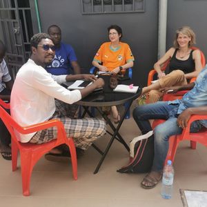 Six researchers are sitting around a table.