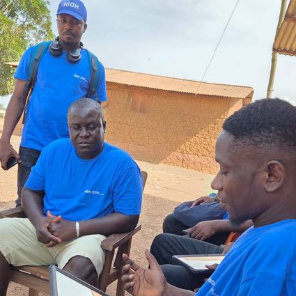 Five people, person with tablet in the foreground