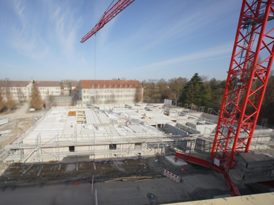 Bird's-eye view photo of construction site with crane